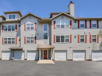 a large apartment building with two garages  at Residences at Westborough Station, Westborough, MA